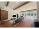 Cozy living room with exposed beams, brick accents, and large windows for plenty of natural light at 53 Weatherstone Pkwy, Marietta, GA 30068