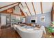 Cozy living room featuring vaulted ceilings, wood beams, a fireplace, and a view into the kitchen at 53 Weatherstone Pkwy, Marietta, GA 30068