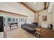 Bright living room with a brick floor, exposed beams, and large windows overlooking the backyard at 53 Weatherstone Pkwy, Marietta, GA 30068
