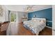 Spacious main bedroom with blue accent wall, hardwood floors and balcony access to enjoy the outdoors at 53 Weatherstone Pkwy, Marietta, GA 30068