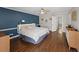 Large primary bedroom with wood floors, recessed lighting, blue accent wall, and plenty of natural light at 53 Weatherstone Pkwy, Marietta, GA 30068