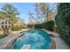 Inground pool with diving board surrounded by brick and concrete and mature trees at 53 Weatherstone Pkwy, Marietta, GA 30068