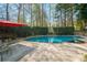 Backyard in-ground pool with a concrete surround and privacy landscaping at 53 Weatherstone Pkwy, Marietta, GA 30068
