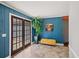 Cozy sun room featuring blue wood paneling, tile flooring, and access to the outdoors at 53 Weatherstone Pkwy, Marietta, GA 30068