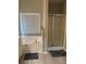 Bathroom features a white soaking tub, glass door shower, and gray mat at 5915 Windsorcreek Dr, Douglasville, GA 30135
