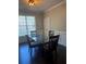 Formal dining room with wainscoting, a modern glass table, and hardwood floors at 5915 Windsorcreek Dr, Douglasville, GA 30135