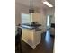 Kitchen area with breakfast bar, white cabinetry, and dark countertops at 5915 Windsorcreek Dr, Douglasville, GA 30135