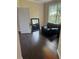 Cozy living room features hardwood floors, a large window, and an elegant black leather chair at 5915 Windsorcreek Dr, Douglasville, GA 30135