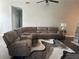 Spacious living room featuring a sectional sofa with cup holders, ceiling fan, and a neutral color scheme at 5915 Windsorcreek Dr, Douglasville, GA 30135