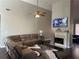 Cozy living room features a fireplace, television, comfortable sectional sofa, and soaring high ceilings at 5915 Windsorcreek Dr, Douglasville, GA 30135