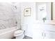 Elegant bathroom features marble tiled shower, a white vanity, and a framed art piece at 2029 Memorial Dr # 32, Atlanta, GA 30317