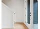 Bright entryway with light wood floors and a white staircase, with a large glass entry door at 2029 Memorial Dr # 32, Atlanta, GA 30317