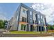 Modern townhome featuring a stylish facade with multiple windows, small balconies, and well-maintained landscaping at 2029 Memorial Dr # 32, Atlanta, GA 30317