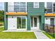 Modern townhome showcasing a vibrant green exterior, clean lines, a small balcony, and a well-maintained lawn at 2029 Memorial Dr # 32, Atlanta, GA 30317