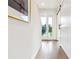 Bright hallway with a white barn door, light wood floors, and a view to the backyard at 2029 Memorial Dr # 32, Atlanta, GA 30317