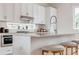 Modern kitchen featuring white cabinets, stainless steel appliances, an island with bar seating, and a window at 2029 Memorial Dr # 32, Atlanta, GA 30317