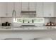 White kitchen with island, a stainless steel range, and a window offering a view at 2029 Memorial Dr # 32, Atlanta, GA 30317