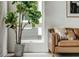 Living room featuring a brown leather sofa, houseplant, and modern decor at 2029 Memorial Dr # 32, Atlanta, GA 30317