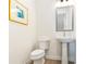 Simple powder room featuring a pedestal sink, and a toilet, with a framed art piece above at 2029 Memorial Dr # 32, Atlanta, GA 30317