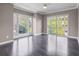 Bright bedroom with large windows, a sliding door to the balcony, and hardwood floors at 2769 Peachtree Ne Rd # 10, Atlanta, GA 30305
