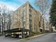 Contemporary multi-story apartment building featuring private balconies, a parking garage, and professional landscaping at 2769 Peachtree Ne Rd # 10, Atlanta, GA 30305