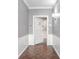 Hallway with hardwood floors, grey walls, crown molding, and door to apartment 10 at 2769 Peachtree Ne Rd # 10, Atlanta, GA 30305