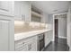 Kitchenette features white cabinets, marble countertops, wine cooler, and under-cabinet lighting at 2769 Peachtree Ne Rd # 10, Atlanta, GA 30305