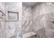 Stunning shower featuring elegant marbled tilework, a built-in niche, and comfortable bench seating at 2769 Peachtree Ne Rd # 10, Atlanta, GA 30305