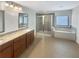 Bright bathroom features double vanities, a glass-enclosed shower, and a soaking tub for a spa-like experience at 3305 Pleasant Manor Ct, Cumming, GA 30028