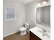 Simple bathroom featuring a single sink vanity, toilet, and window at 3305 Pleasant Manor Ct, Cumming, GA 30028
