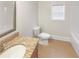 Cozy bathroom featuring a granite countertop vanity, toilet, and window at 3305 Pleasant Manor Ct, Cumming, GA 30028