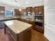 Well-appointed kitchen featuring granite countertops, stainless steel appliances, an island, and ample cabinet space at 3305 Pleasant Manor Ct, Cumming, GA 30028