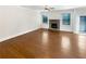 Spacious living room showcasing hardwood floors, a stone fireplace, and ample natural light for a welcoming space at 3305 Pleasant Manor Ct, Cumming, GA 30028