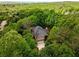 Aerial view of a home nestled in a lush green forest, offering privacy and natural beauty at 3895 Overlake Dr, Cumming, GA 30041