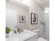 Bright white bathroom with a marble countertop, modern fixtures, and a glass-enclosed tiled shower at 3895 Overlake Dr, Cumming, GA 30041