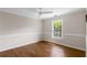 Inviting bedroom with hardwood floors, neutral paint, ample natural light from a large window at 3895 Overlake Dr, Cumming, GA 30041