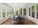 Elegant dining room features a round table, hardwood floors and lots of natural light from the large windows at 3895 Overlake Dr, Cumming, GA 30041