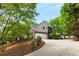 Front exterior view of a two-story home with a spacious driveway and a well-manicured lawn at 3895 Overlake Dr, Cumming, GA 30041
