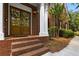 Charming front entrance with double wooden doors, brick steps, and classic architectural details at 3895 Overlake Dr, Cumming, GA 30041