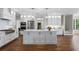 Spacious kitchen with a large center island, stainless steel appliances and beautiful wood flooring at 3895 Overlake Dr, Cumming, GA 30041