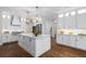 Modern kitchen features a large center island, stainless steel appliances, and elegant white cabinetry at 3895 Overlake Dr, Cumming, GA 30041