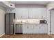 Fully equipped kitchenette featuring white cabinetry and stainless steel appliances, ideal for a small space at 3895 Overlake Dr, Cumming, GA 30041