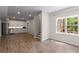 Open-concept living space with a kitchenette, hardwood floors, and large windows overlooking the backyard at 3895 Overlake Dr, Cumming, GA 30041