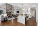 Bright open-concept living area with stone fireplace, modern furnishings and a spacious kitchen area at 3895 Overlake Dr, Cumming, GA 30041