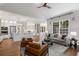 Open-concept space with fireplace, kitchen and dining area with ample windows and hardwood floors at 3895 Overlake Dr, Cumming, GA 30041