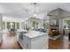 Open-concept living area boasts a stone fireplace, hardwood floors, and large windows with natural light at 3895 Overlake Dr, Cumming, GA 30041