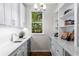 Convenient pantry with built-in shelving, sink, countertop space, and wine cooler at 3895 Overlake Dr, Cumming, GA 30041
