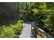 A tranquil backyard featuring a wooden deck and pristine in-ground pool at 4 W Wesley Nw Rdg, Atlanta, GA 30327
