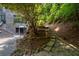 Backyard featuring stone steps and lush landscaping to modern home at 4 W Wesley Nw Rdg, Atlanta, GA 30327