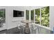 Dining area with modern table, transparent chairs, large windows and backyard views at 4 W Wesley Nw Rdg, Atlanta, GA 30327
